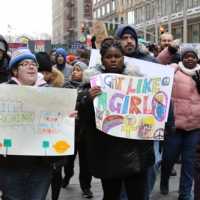 teen with  fighting like a girl sign