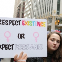 teen holding expect resistance sign
