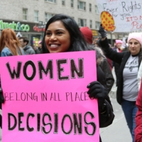 Marcher with sign Women Belong in All Places