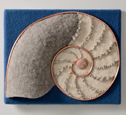copper spirals define a nautilus of grey and white felted wool against a sea blue background