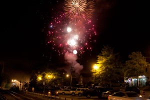 explosions in the night sky over a village