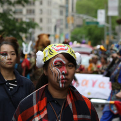 women painted faces dance parade