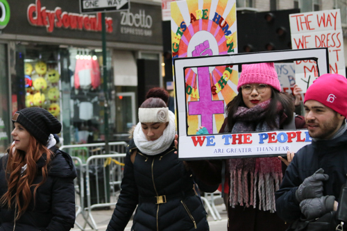 We the People are Greater Than Fear picture frame sign carried by marcher 