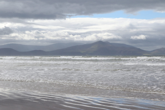 Mountain peak, silver light and rolling surf create drama