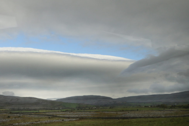 thick grey and white clouds over Dingle landscape