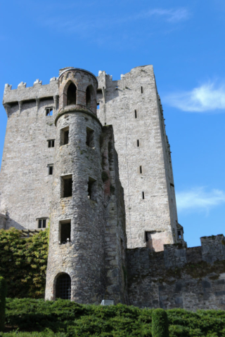 Blarney Castle and stone tower against deep blue sky