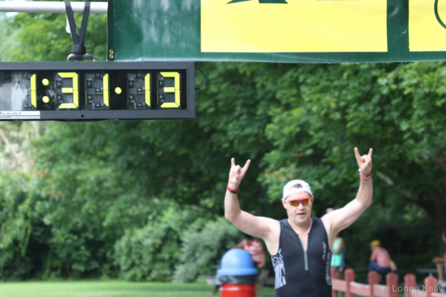 Pawling Triathlon Finisher bib white hat arms up