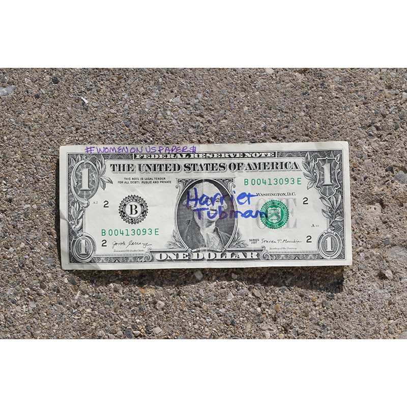 one dollar bill with Harriet Tubman written on it