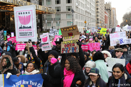 crowded street hundreds of marchers with signs