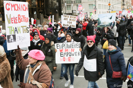 Marchers sign empowered women empower women