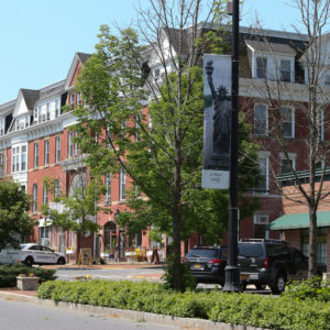 statue of liberty banner hanging on lamp post village of pawling