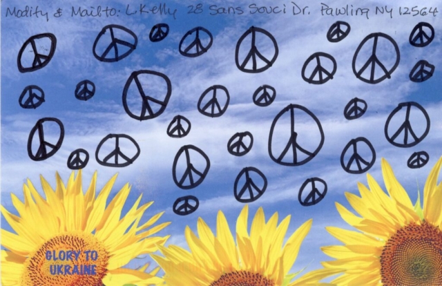 peace signs floating  in blue sky over yellow sunflowers