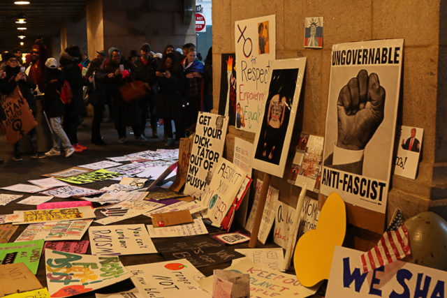 Grand Central station at end of march people have left signs on the ground crowd stops to read