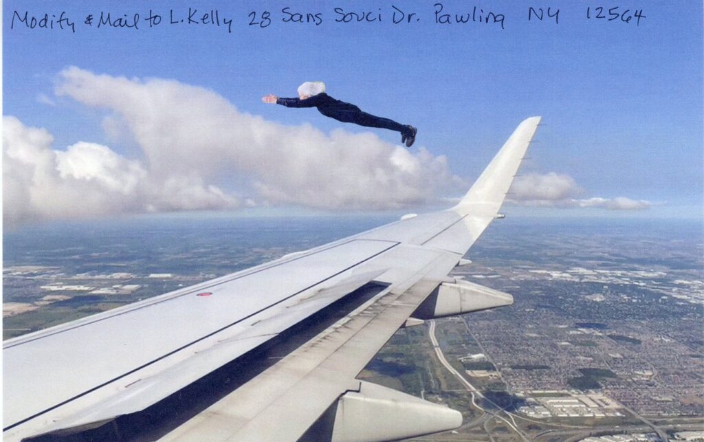 Woman with white hair and fitted black clothing  flying over wing of plan over city