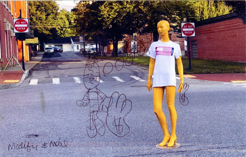 Mannequin in road holding purse with dollar sign along outline of smaller person holding larger purse with dollar sign 